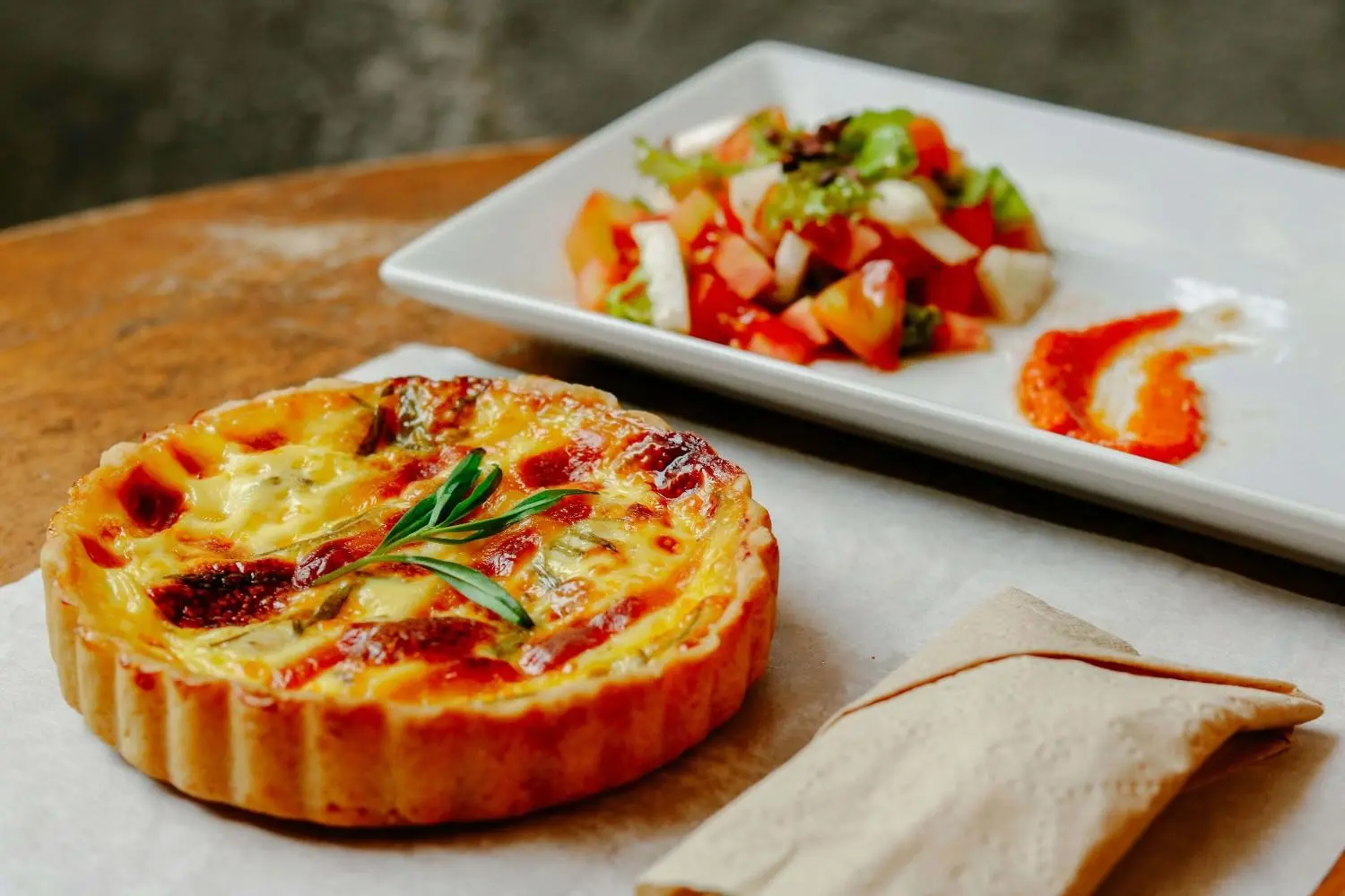 Quiche lorraine francesa servida con ensalada fresca